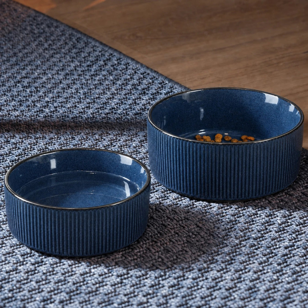 Large and small blue ceramic bowls on a rug