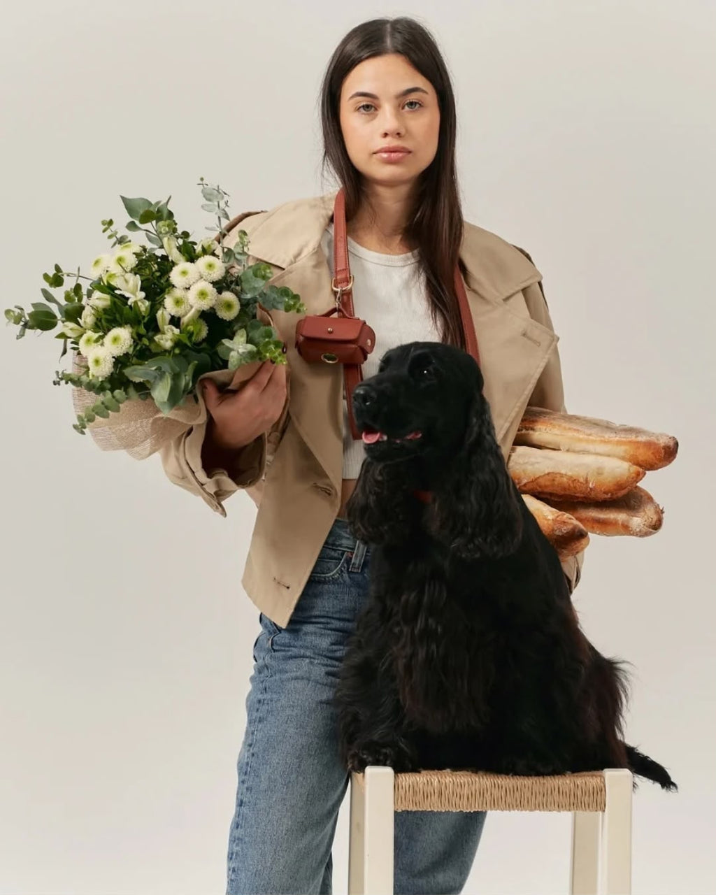 Woman with a black spaniel and the cognac pouch