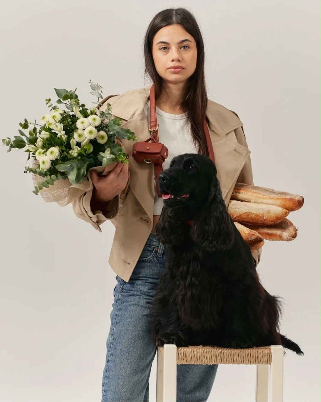 Woman with a black spaniel and the cognac pouch